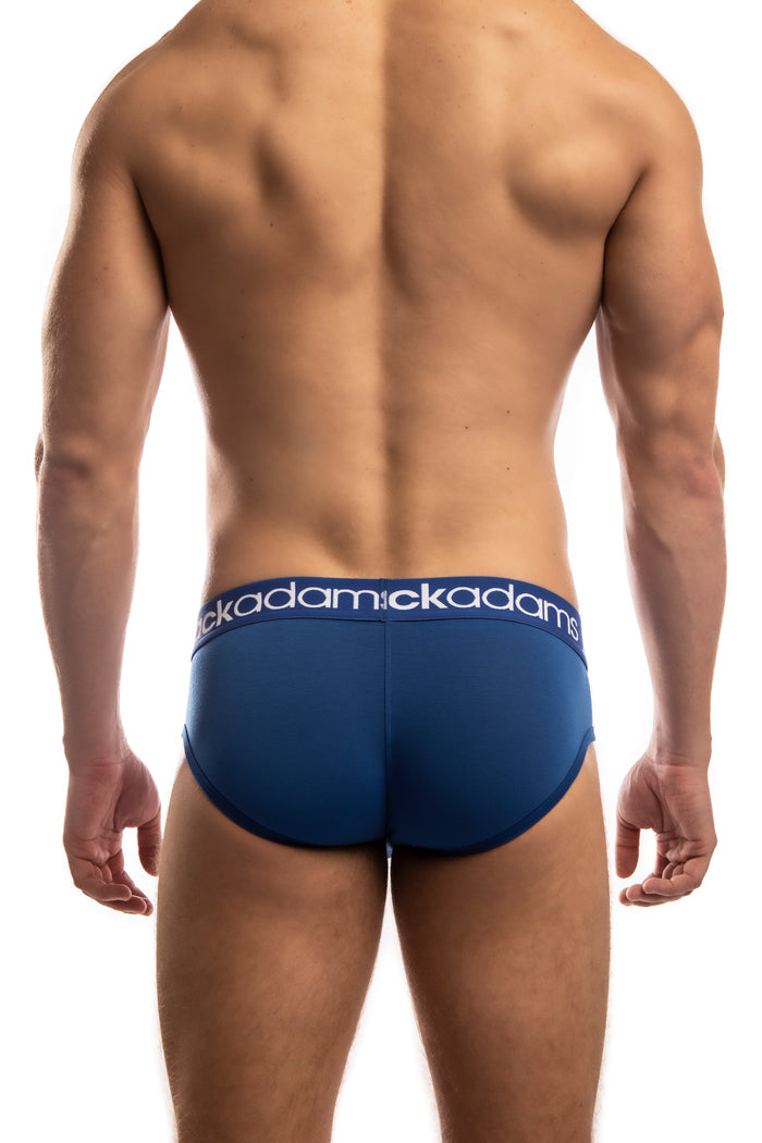 Shirtless man standing in front of a white background wearing a pair of Jack Adams Icon Cool Modal Brief in international blue (back  view)