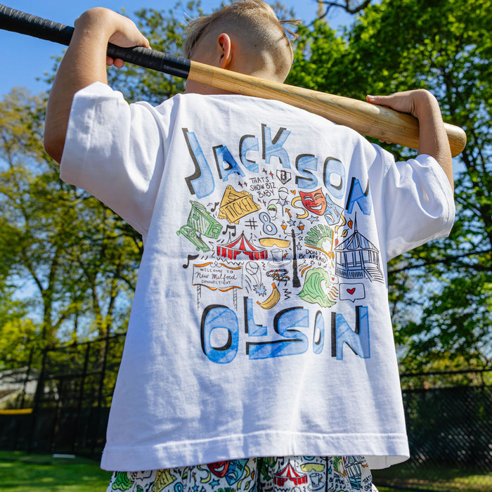 Close-up back view of the white youth Jackson Olson x BL101 relaxed tee highlighting the full illustrated graphic and "Jackson Olson" lettering