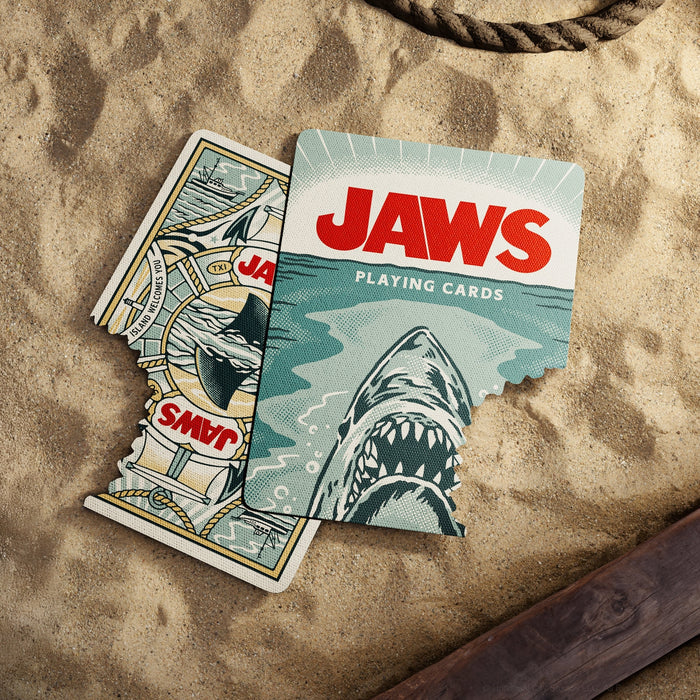 Playing cards deck box with shark artwork and JAWS text, with cards fanned beside