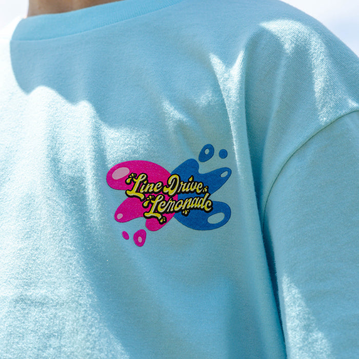 Youth model wearing blue youth graphic tee with "Lemon Burst" design