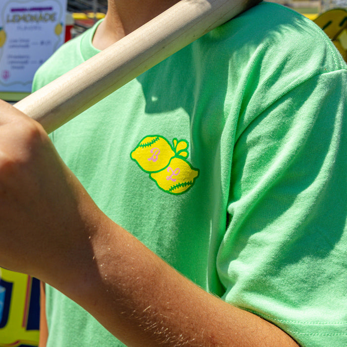 Youth model wearing green youth graphic tee with "Lemon Dingers" design