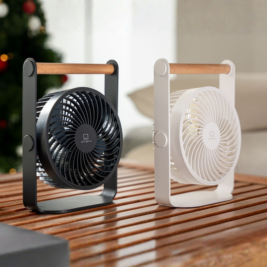Portable fan with wooden handle, black front grille; white fan beside it