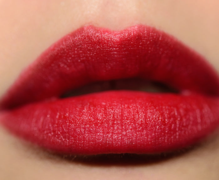 M.A.C Powder Kiss Lipstick in various shades, new in box, showcasing vibrant colors and sleek packaging.