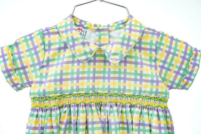 This festive outfit combines timeless plaid design with intricate smocking, perfect for celebrating Mardi Gras in style.