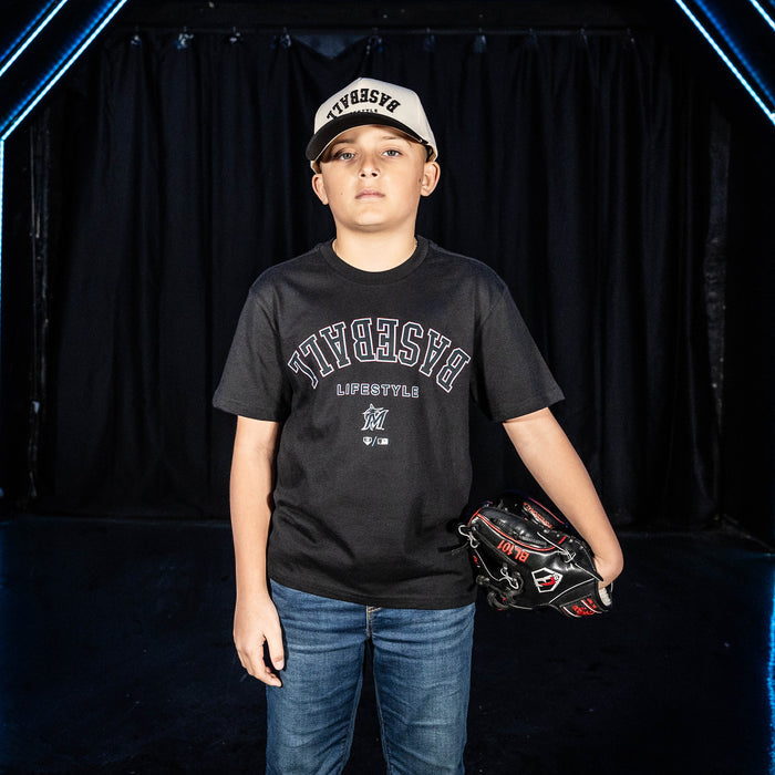 Youth model wearing black youth graphic tee with "Miami Marlins Upside Down" design