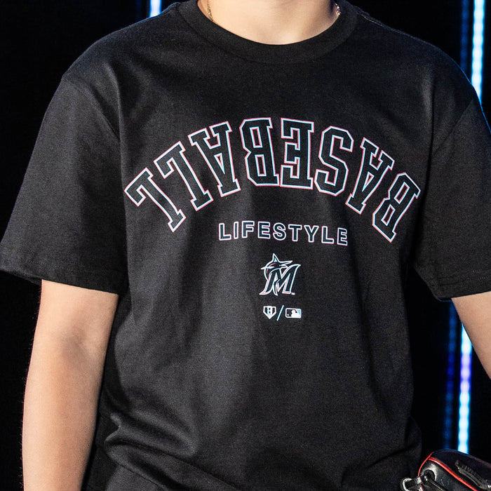 Youth model wearing black youth graphic tee with "Miami Marlins Upside Down" design