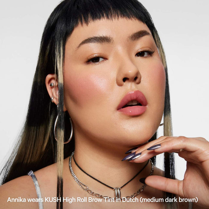 Milk Makeup Kush High Roll defining eyebrow gel in various shades, featuring a close-up of the product tube and brush applicator.