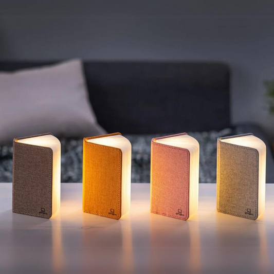 Four mini linen smart booklights in dark, orange, blush pink, and gray colors