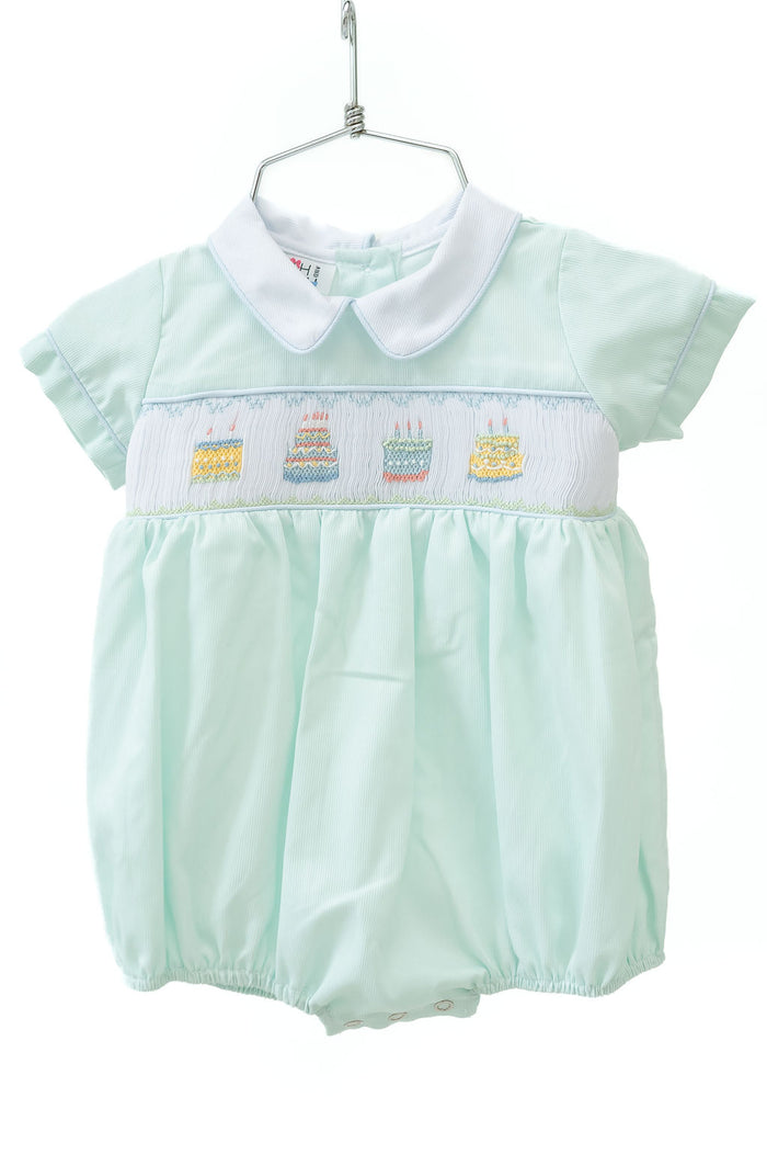 The smocked mint green birthday cake bubble is perfect for a little boy’s big celebration, filled with festive charm.