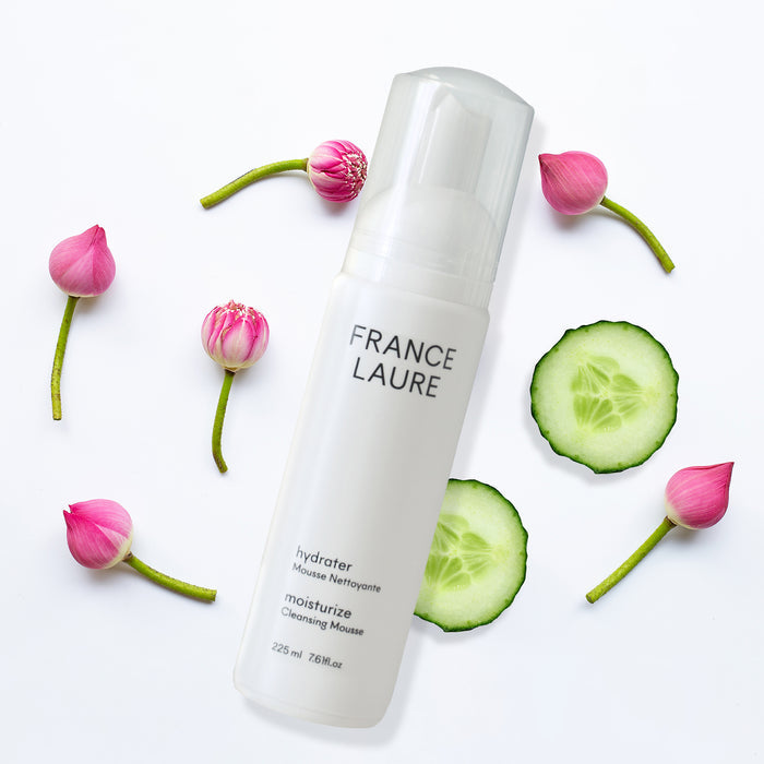 France Laure hydrater moisturize cleansing mousse with pink lotus buds and cucumber slices on white background