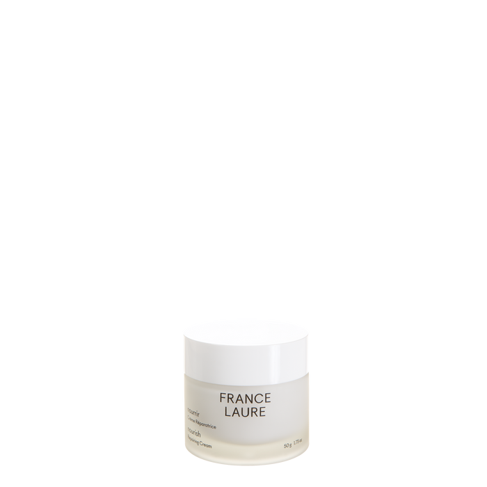 Moisturizing nourishing repairing cream in a glass jar with white lid on white background