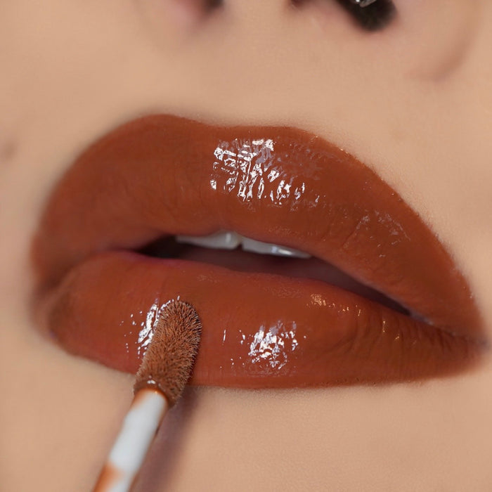 Neutral Brown Liner Lip Combos Lip-on model shot: Brown Suga Nude Glass Gloss applied on light to deep skin tone — pigmented high-shine finish