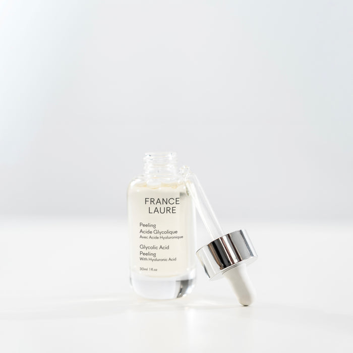 France Laure Glycolic Acid Peeling with Hyaluronic Acid in clear glass bottle with dropper, 30ml, on white background