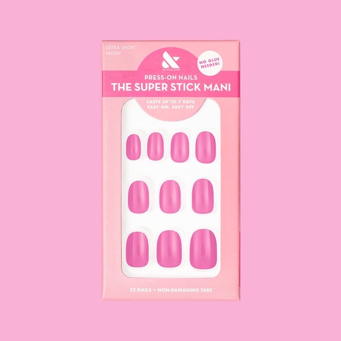 Peony | Extra Short | Round - Tab Press-On nails in bright pink with glossy finish arranged in packaging on pink background
