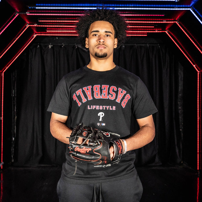 Youth model wearing black youth graphic tee with "Philadelphia Phillies Upside Down" design