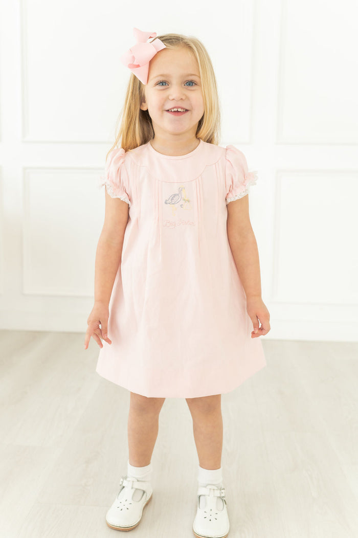 This heirloom-quality dress is perfect for a little girl to create cherished memories as the new big sister.