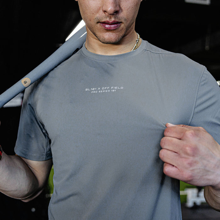Man wearing a gray t-shirt with text.