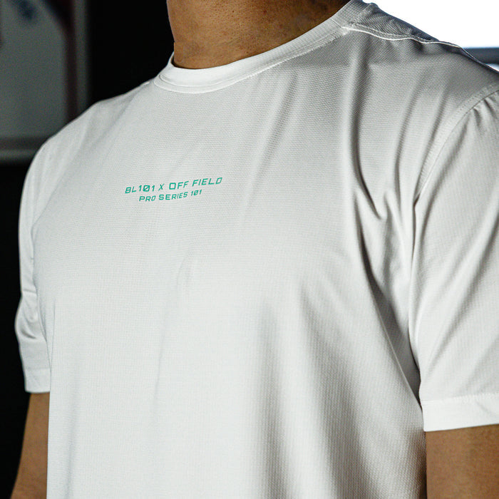 White t-shirt with text on the chest worn by a person, blurred background