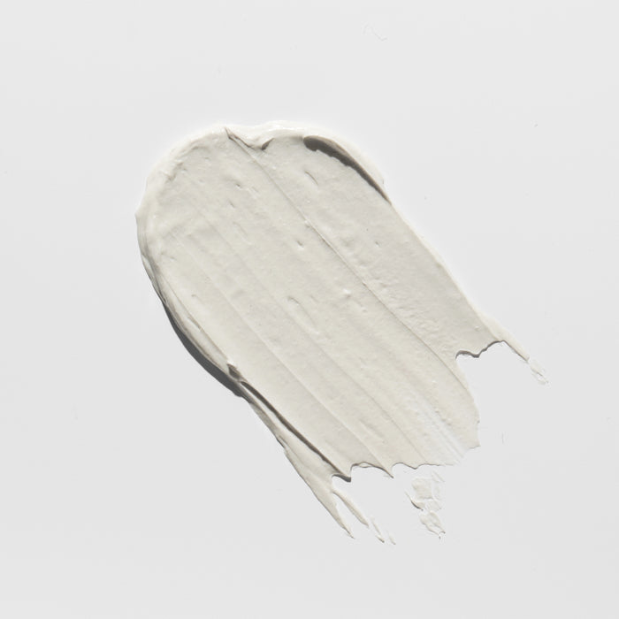 Creamy white skincare product swatch with smooth texture on clean background, ideal for all skin types and ages