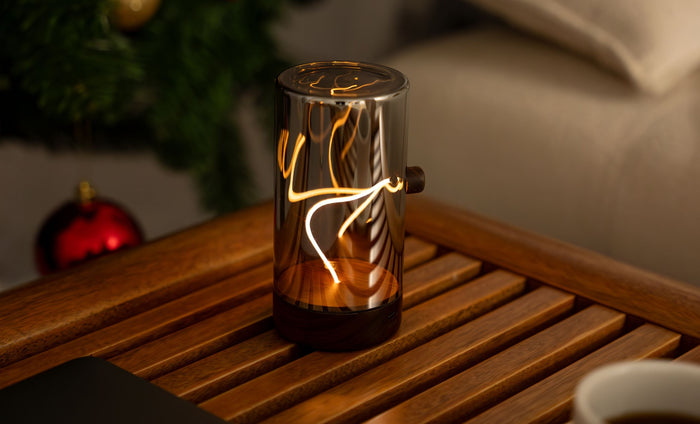 Drift Light glass cylinder lamp with warm flowing filament pattern and walnut base