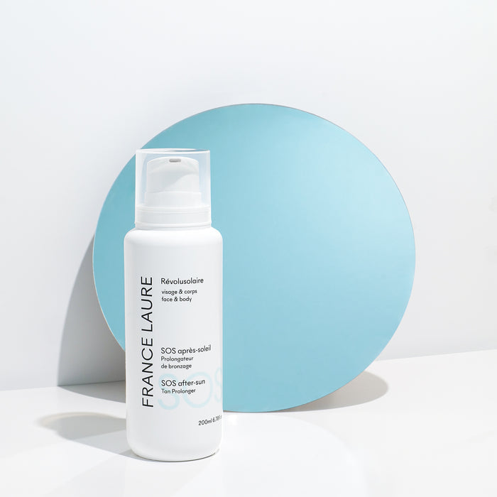 France Laure SOS after-sun tan prolonger for face & body, 200ml white bottle with pump, minimalist blue and white background