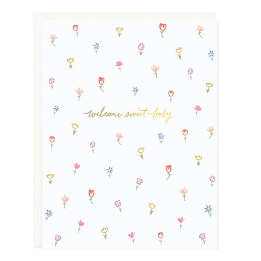 Floral baby blanket with colorful tulip icons and "welcome sweet baby" print