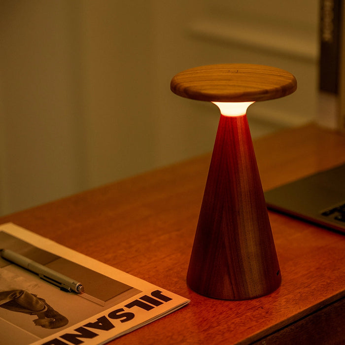 Large wood table lamp with white shade and dark fluted pedestal base, warm lit