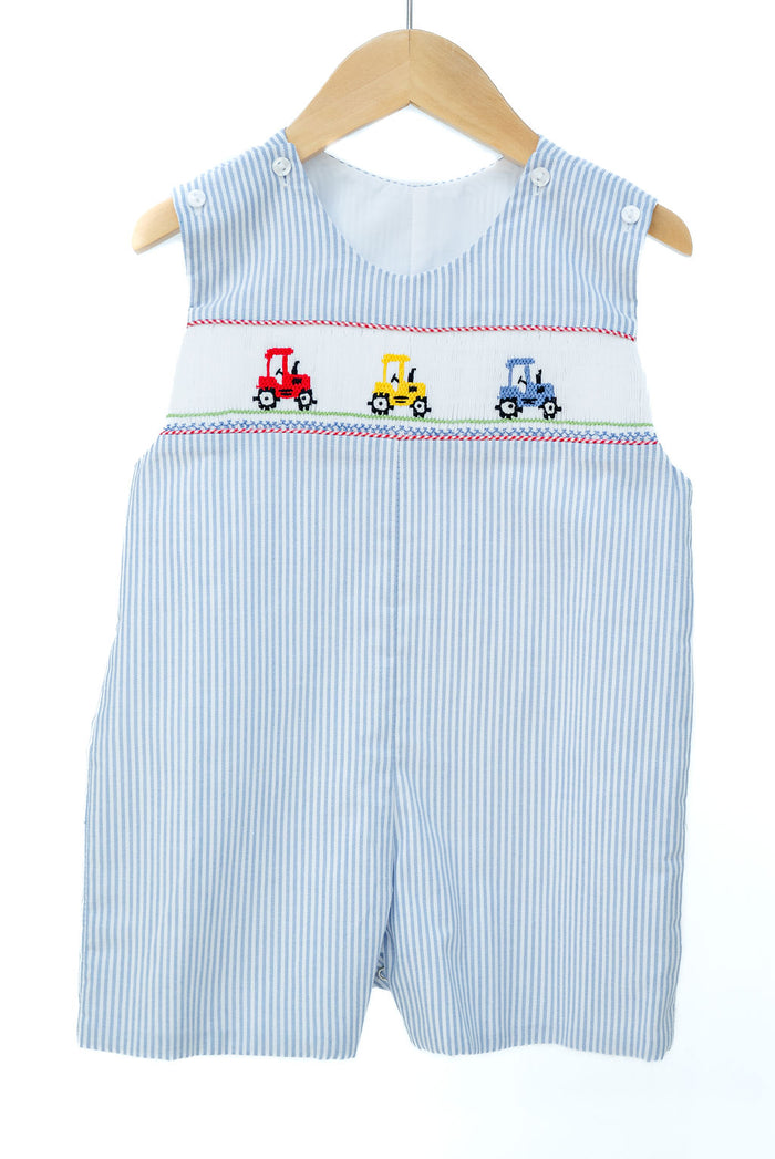Smocked Tractor Jon Jon by Ruth and Ralph, blue striped seersucker with hand-smocked tractor embroidery, on hanger