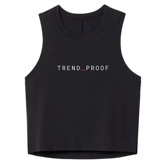 Front view of a black sleeveless athletic tank with “TREND_PROOF” printed across the chest in white lettering with a red underscore.