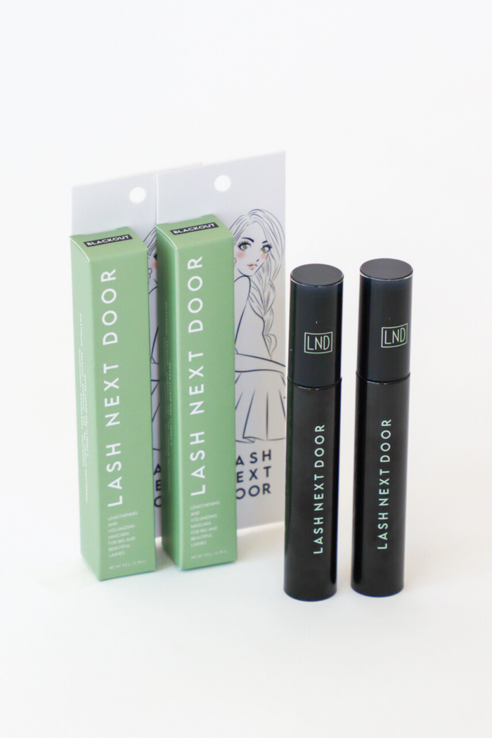 Lash Next Door product packaging and applicators on a white background