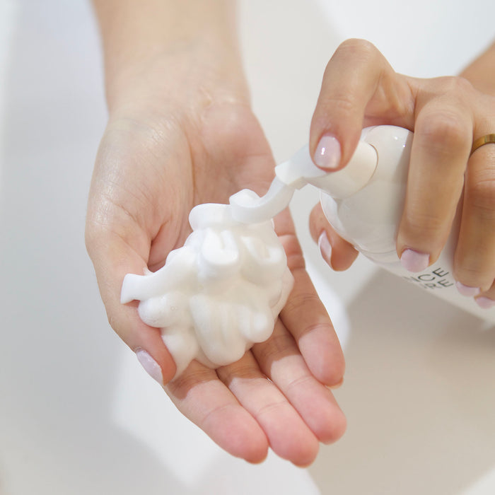 Rich foaming cleanser dispensed into hand, showcasing gentle skincare texture for all skin types