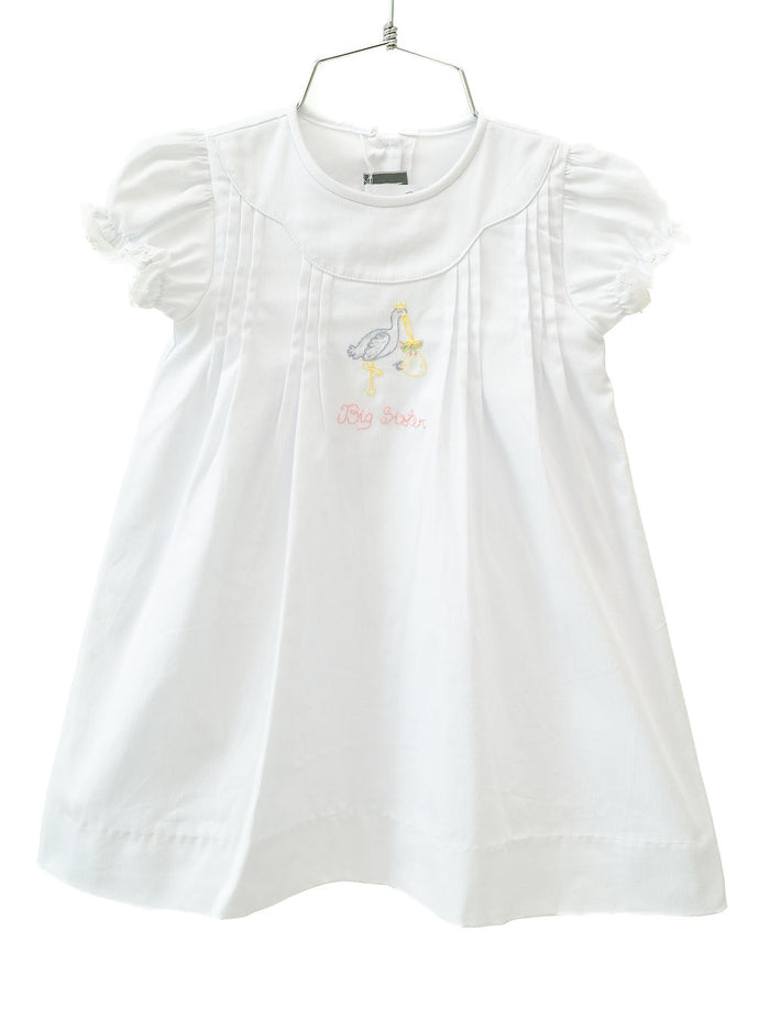 The White Big Sister Stork Dress is a timeless choice for celebrating a special milestone.
