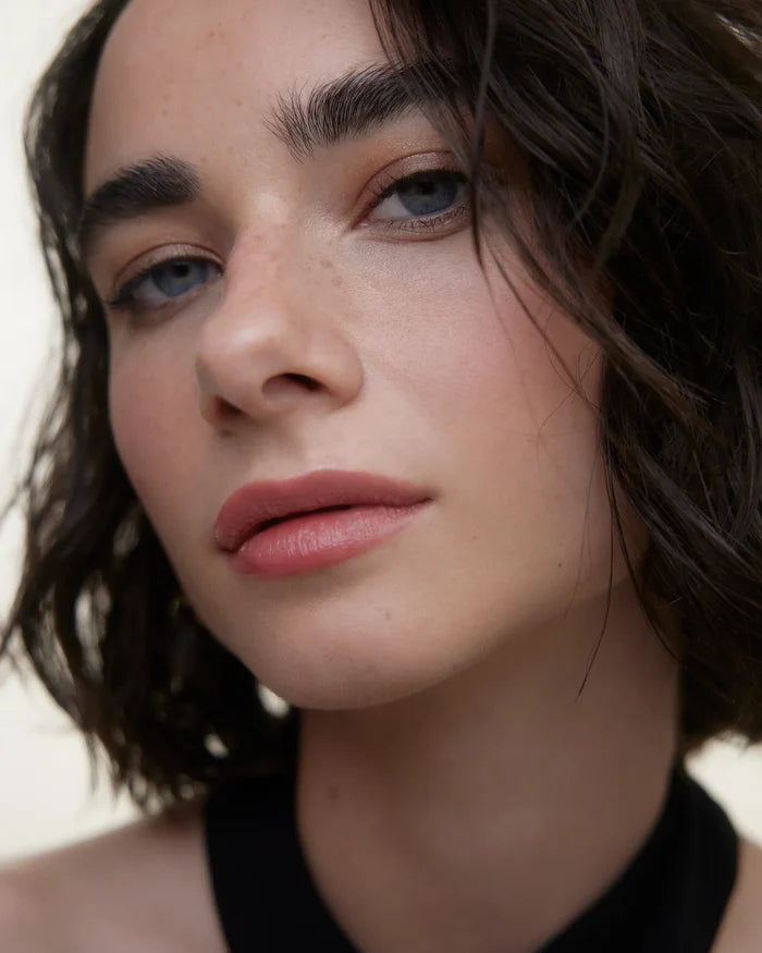 WONDERBLUSH La Laque Tinted Lip Oil in Abricot, light skin model showcasing glossy, tinted lip color on smooth lips.